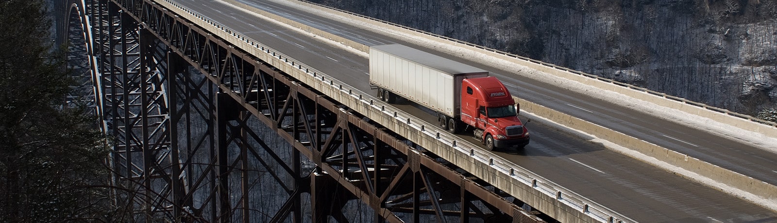 red semi truck on bridge