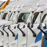 line of semi trucks for sale in parking lot